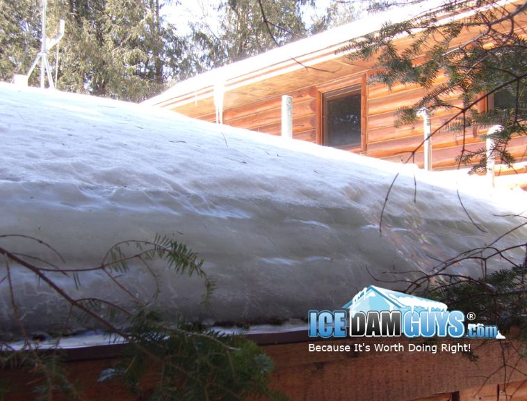 This photo shows a solid slab of ice over one-foot in depth on a cabin roof. It's an ice dam that will need to be steamed off or the home could risk water leaks or collapsed ceilings.
