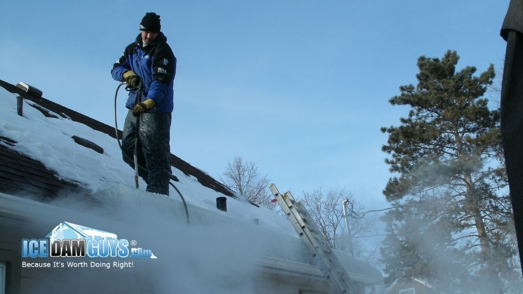 Ice Dam Guys®: Ice Dam Experts removing an ice dam from a customer's home.