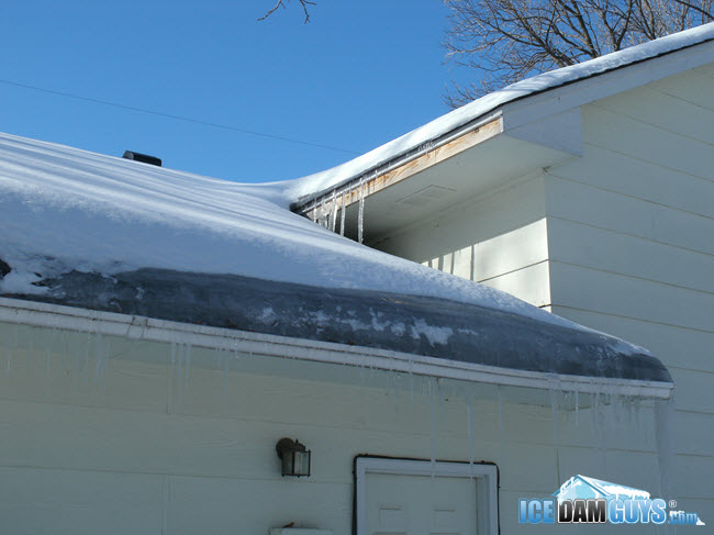 Thick ice and snow on frozen gutters